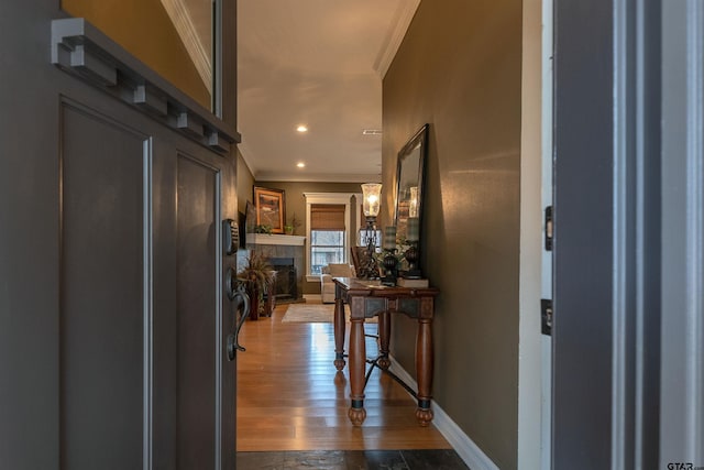 corridor with crown molding and hardwood / wood-style flooring