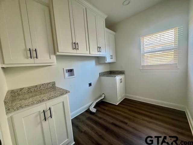 clothes washing area featuring dark hardwood / wood-style flooring, cabinets, and hookup for a washing machine