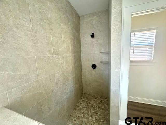 bathroom with a tile shower