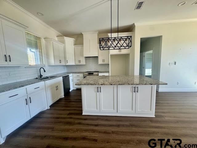 kitchen with white cabinetry, a center island, dishwasher, and sink