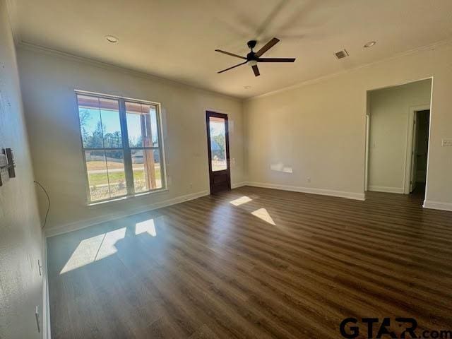 unfurnished room featuring ceiling fan, ornamental molding, and dark wood-type flooring