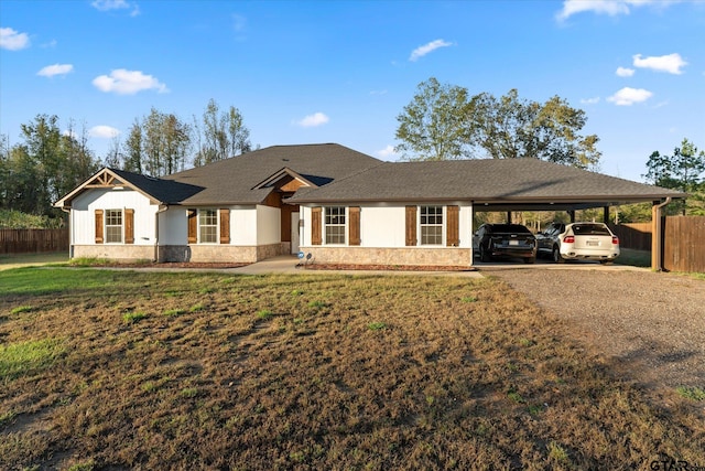 ranch-style home featuring a front yard and a carport