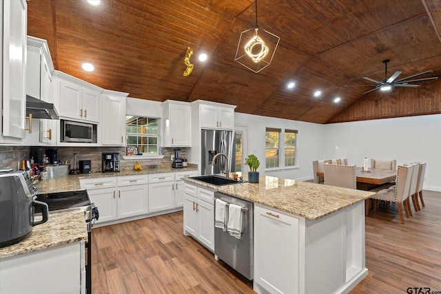 kitchen with white cabinetry, a center island with sink, light hardwood / wood-style floors, and appliances with stainless steel finishes