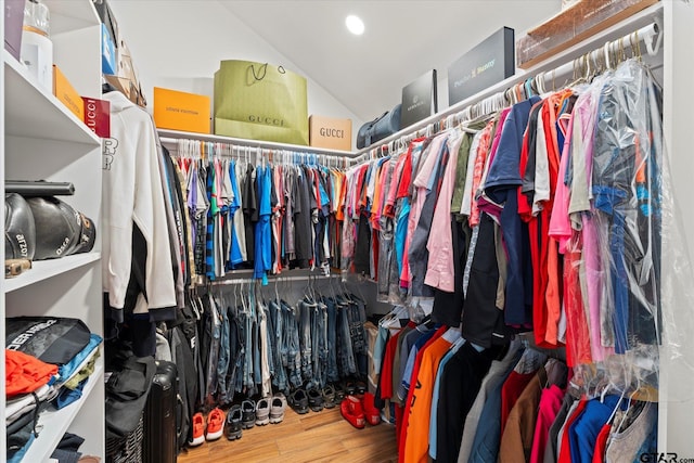 spacious closet with hardwood / wood-style floors and lofted ceiling