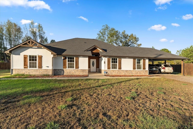 ranch-style home featuring a front yard and a carport