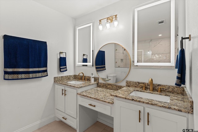 bathroom featuring tiled shower, vanity, and toilet