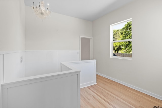 4456 Fm 2767, Tyler, TX 75708 - spare room featuring light wood finished floors, a chandelier, and baseboards