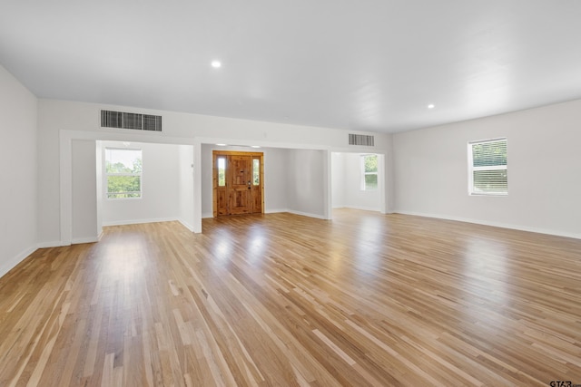 4456 Fm 2767, Tyler, TX 75708 - unfurnished living room with plenty of natural light, light wood-type flooring, and baseboards