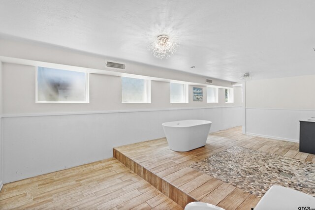 4456 Fm 2767, Tyler, TX 75708 - full bath featuring wood finished floors and a freestanding tub