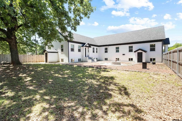 4456 Fm 2767, Tyler, TX 75708 - back of property with roof with shingles, stucco siding, a shed, an outbuilding, and a fenced backyard
