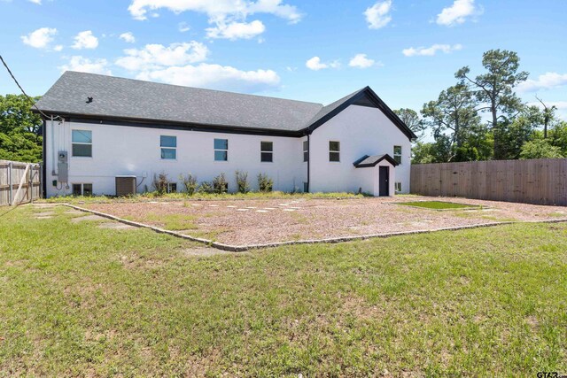4456 Fm 2767, Tyler, TX 75708 - rear view of property featuring central air condition unit, fence, and a lawn