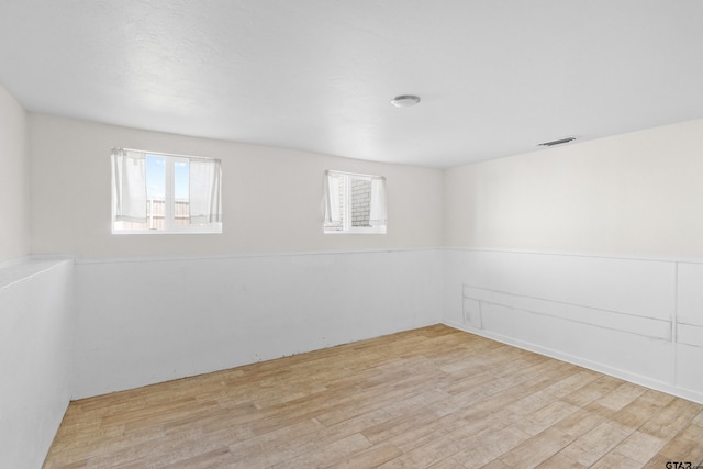 4456 Fm 2767, Tyler, TX 75708 - empty room with visible vents, wood finished floors, and wainscoting