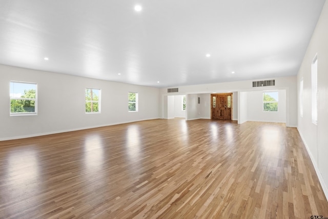4456 Fm 2767, Tyler, TX 75708 - unfurnished living room with light wood-type flooring, baseboards, visible vents, and plenty of natural light