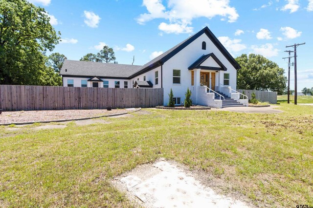 4456 Fm 2767, Tyler, TX 75708 - bungalow-style house with stucco siding, fence, and a front yard