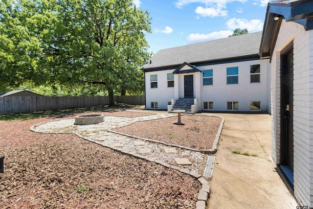 4456 Fm 2767, Tyler, TX 75708 - view of yard featuring a fenced backyard, an outdoor fire pit, entry steps, and a patio area