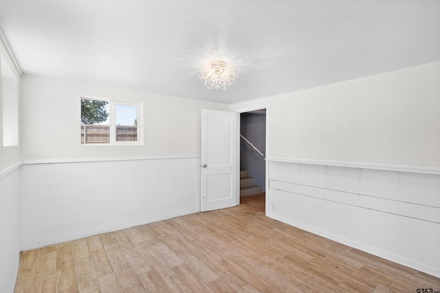 4456 Fm 2767, Tyler, TX 75708 - unfurnished room featuring wood finished floors, a chandelier, and stairway
