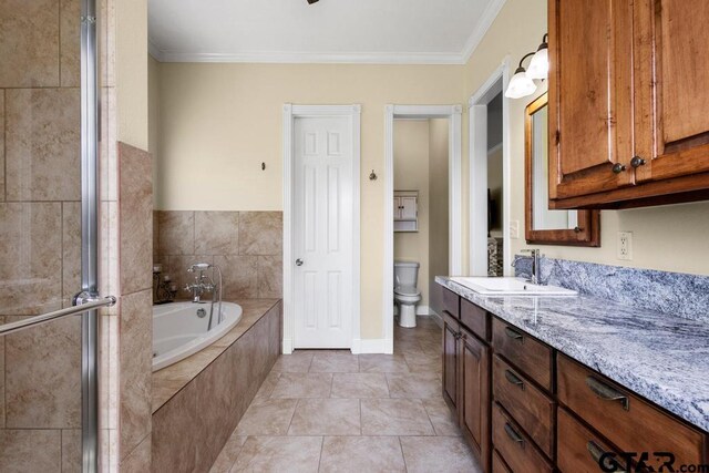 full bathroom with a garden tub, toilet, crown molding, and vanity