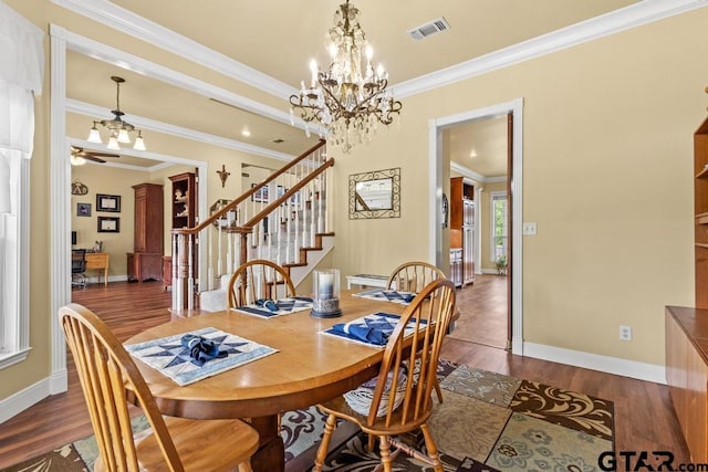 dining space featuring crown molding, stairs, an inviting chandelier, and dark wood-type flooring