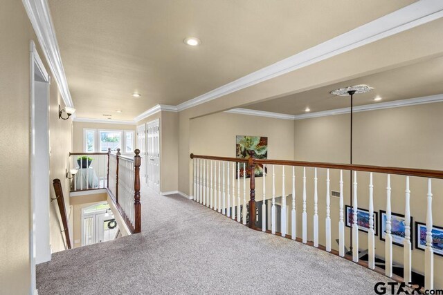 corridor featuring recessed lighting, an upstairs landing, baseboards, ornamental molding, and carpet floors