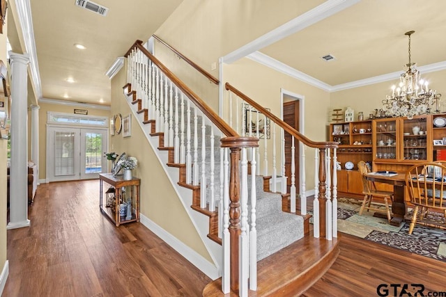 interior space with baseboards, visible vents, wood finished floors, and crown molding