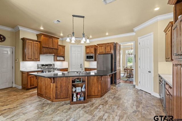 kitchen with an inviting chandelier, a sink, brown cabinets, and appliances with stainless steel finishes