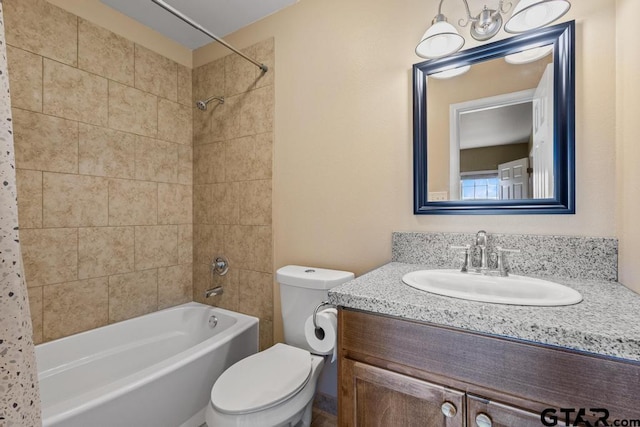bathroom featuring vanity, toilet, and shower / bathtub combination