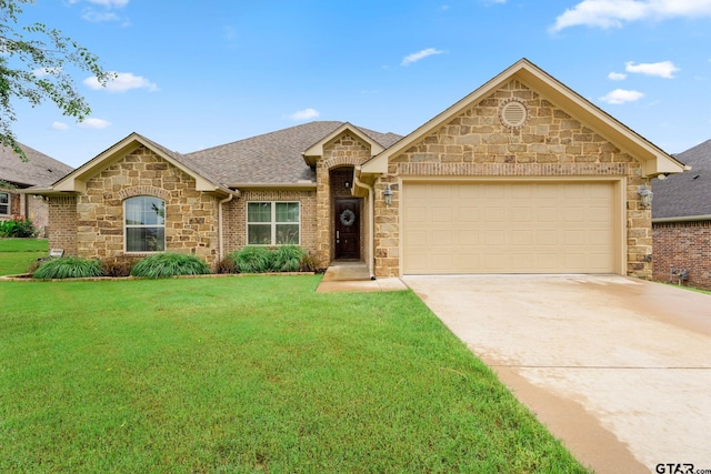 view of front of property featuring a garage and a front lawn