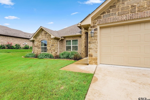 front facade featuring a garage and a front yard