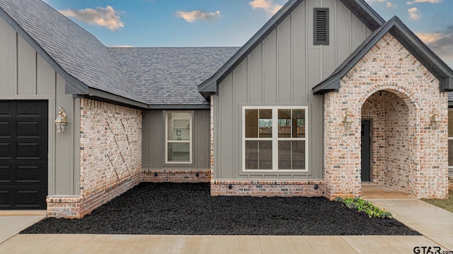 view of exterior entry with a garage