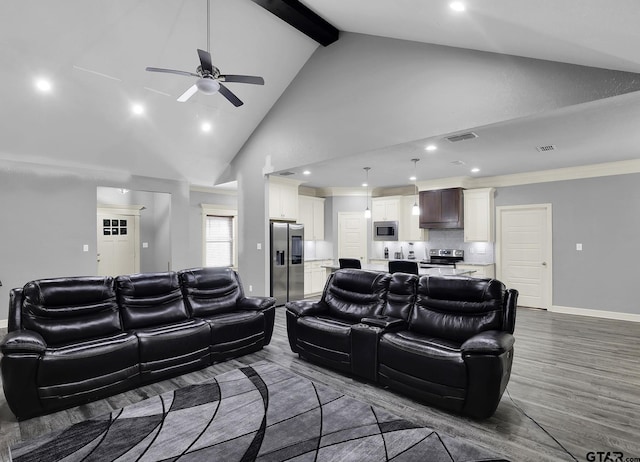 living room with hardwood / wood-style floors, high vaulted ceiling, ceiling fan, and beam ceiling