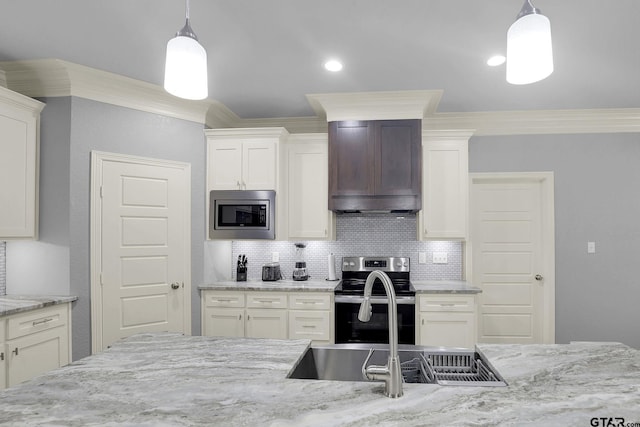 kitchen featuring pendant lighting, ornamental molding, custom range hood, and appliances with stainless steel finishes