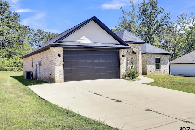 single story home featuring a garage, central air condition unit, and a front yard