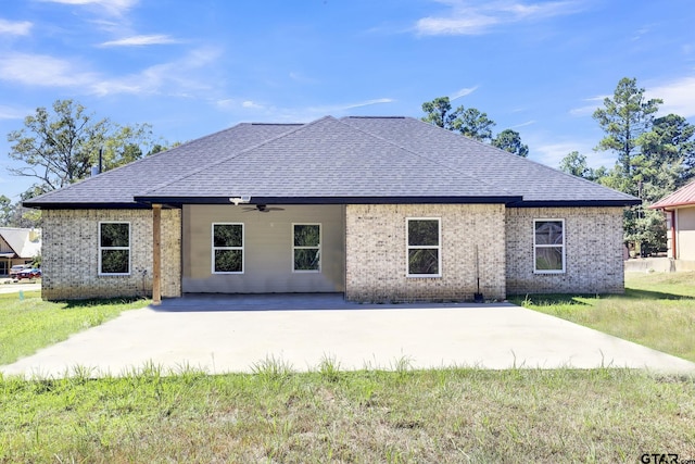 back of property featuring ceiling fan, a patio area, and a yard