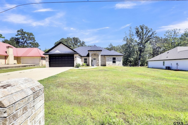 view of front of property with a garage and a front lawn