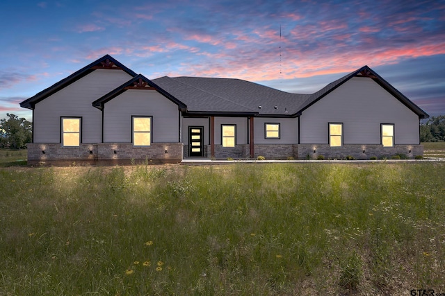 view of back house at dusk