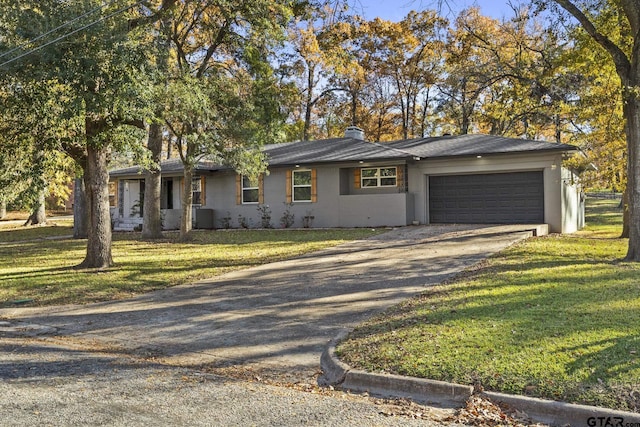 ranch-style house with a garage and a front yard