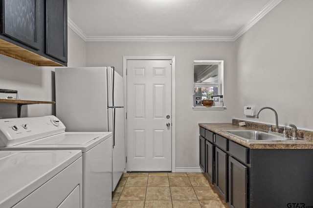 laundry area featuring sink, crown molding, light tile patterned floors, cabinets, and washer and dryer