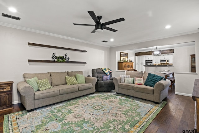 living room featuring crown molding, dark wood-type flooring, and ceiling fan