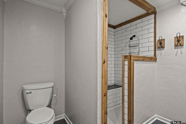 bathroom featuring ornamental molding and toilet