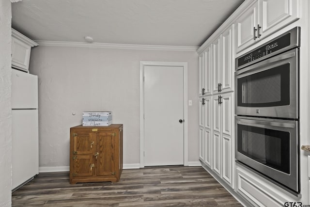 kitchen featuring stainless steel double oven, dark hardwood / wood-style floors, white cabinets, and white fridge