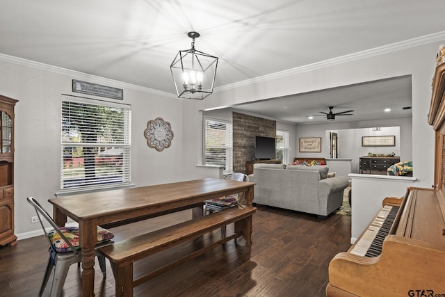 dining area featuring dark hardwood / wood-style flooring, crown molding, and ceiling fan with notable chandelier