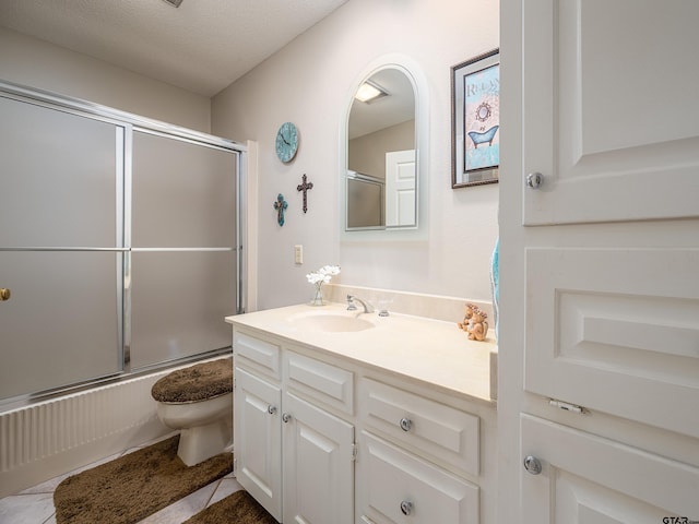6109 Stoneleigh Dr, Tyler, TX 75703 - full bath featuring toilet, tile patterned flooring, vanity, and shower / bath combination with glass door
