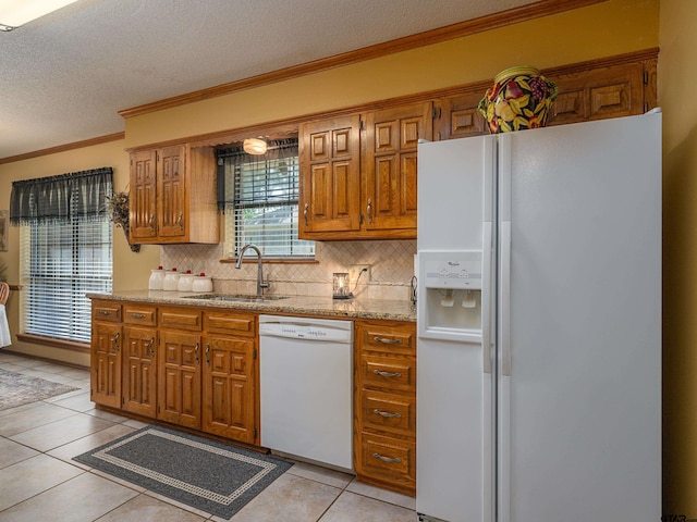 6109 Stoneleigh Dr, Tyler, TX 75703 - kitchen featuring brown cabinets, white appliances, tasteful backsplash, and a sink