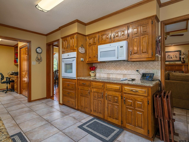 6109 Stoneleigh Dr, Tyler, TX 75703 - kitchen featuring white appliances, decorative backsplash, and brown cabinets