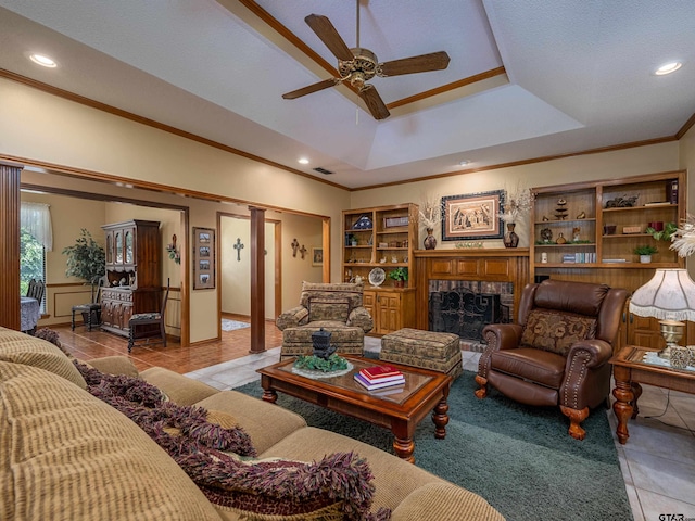 6109 Stoneleigh Dr, Tyler, TX 75703 - living area with light tile patterned flooring, visible vents, crown molding, a brick fireplace, and a ceiling fan