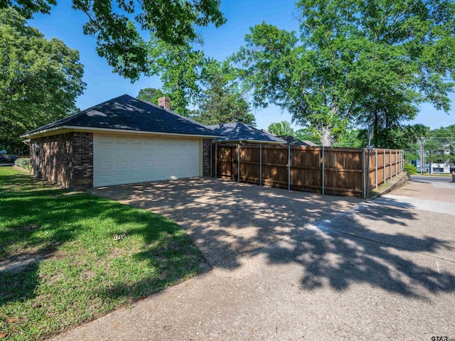 6109 Stoneleigh Dr, Tyler, TX 75703 - view of property exterior featuring brick siding, a chimney, fence, and a garage