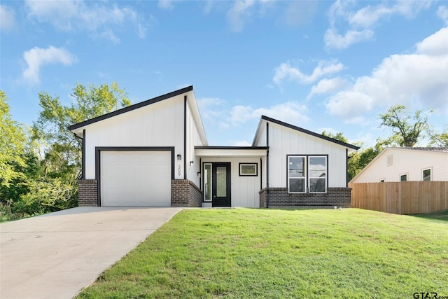 view of front of home with a garage and a front yard