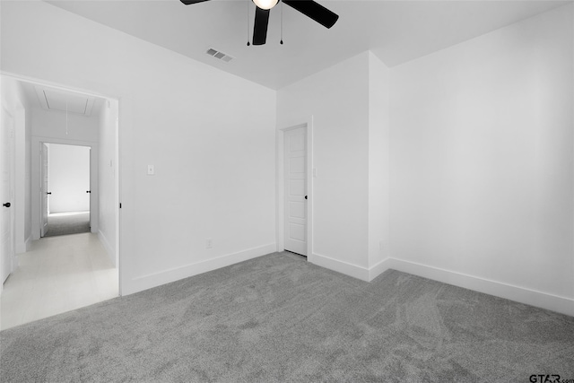 spare room with light colored carpet and ceiling fan