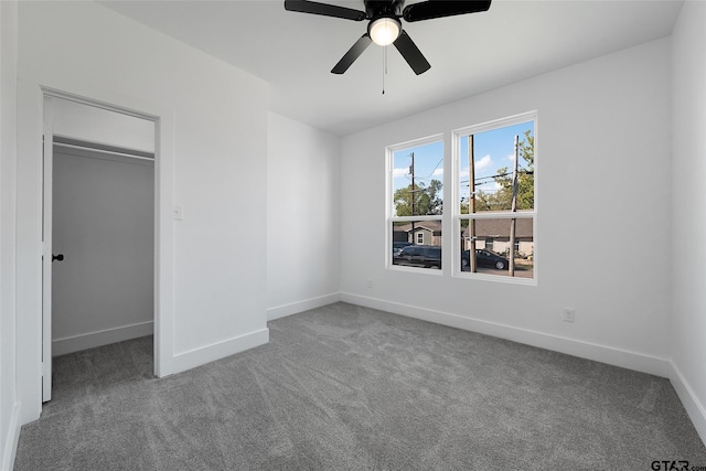 unfurnished bedroom with a closet, carpet, and ceiling fan