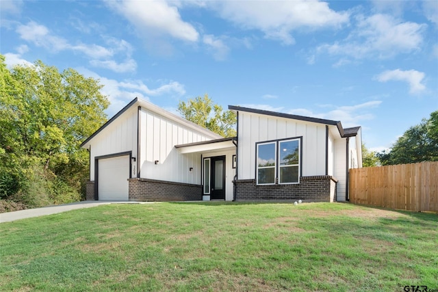 view of front of property with a garage and a front yard